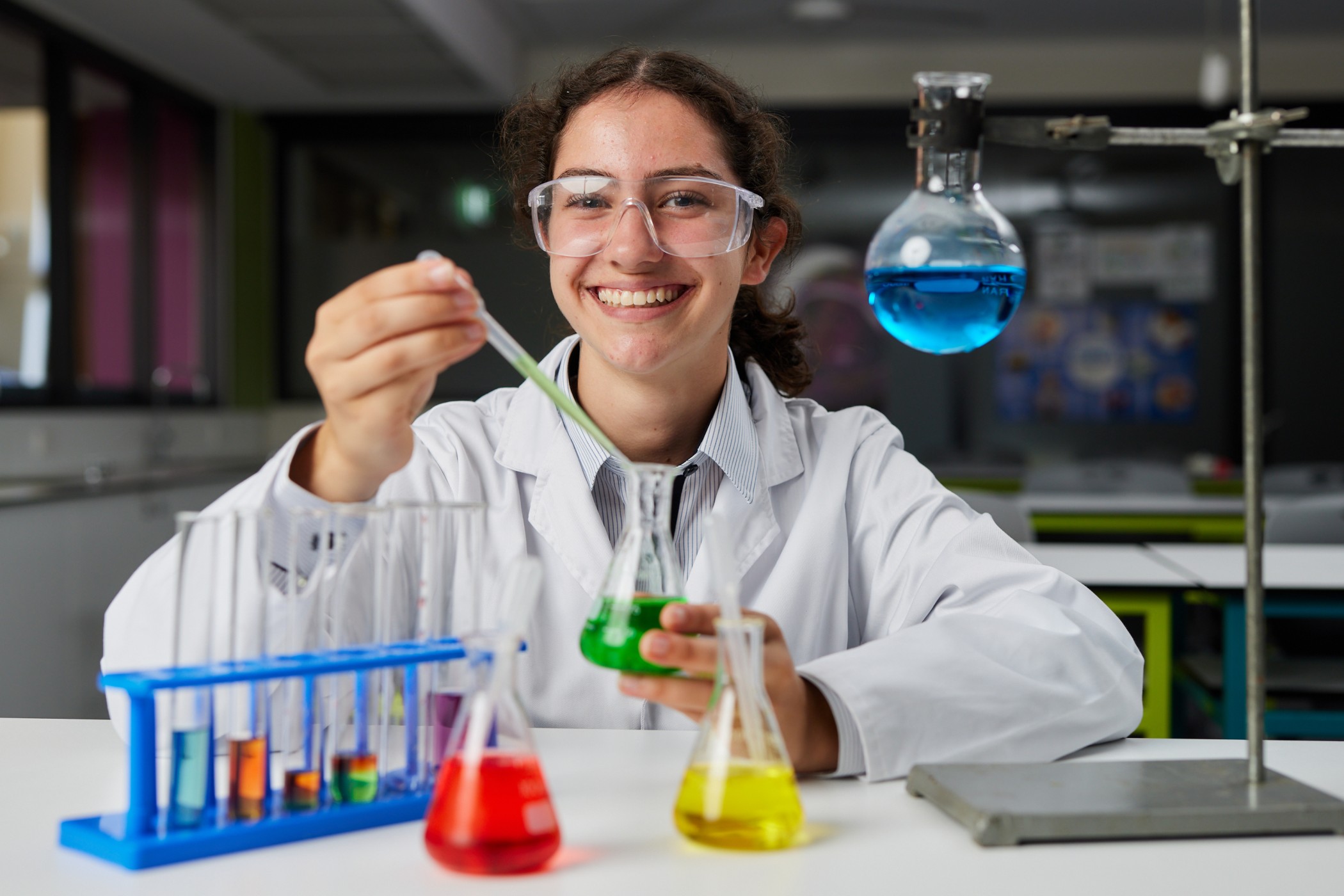 A photo showing a student in a science lab performing an experiment