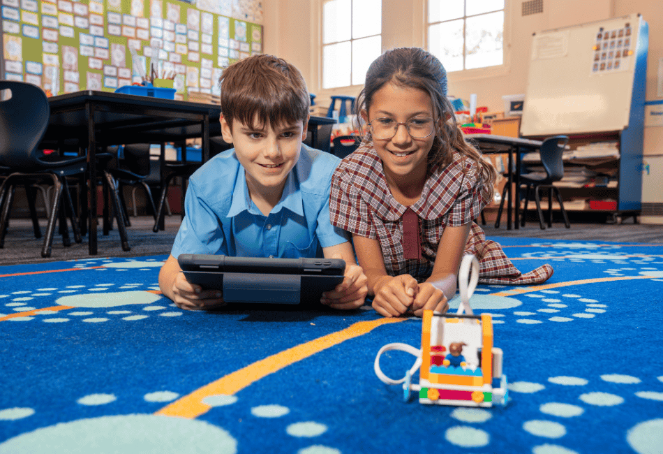 A photo showing two Sydney Catholic Schools students exploring STEM through coding and robotics.